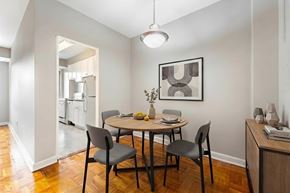 Washington apartment for rent - A dining room with a table set for two and a framed picture on the wall.