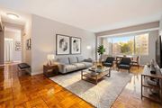 Washington apartment for rent - A living room with a grey sofa, a grey couch, a grey chair, a grey rug, a grey coffee table, a grey floor lamp, a grey wall, a grey door, a grey wall, a grey wall, a grey