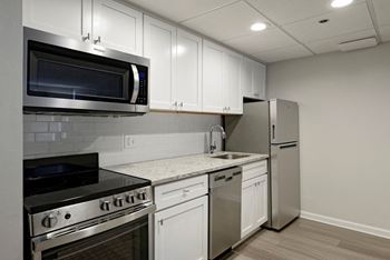 Renovated kitchen with granite countertops and stainless steel appliances