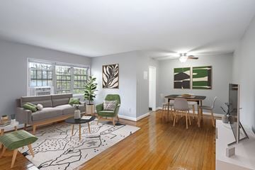 Alexandria apartment for rent - A living room with a grey couch, a green chair, a coffee table, and a dining table with chairs.