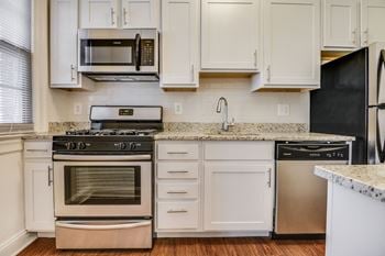 Renovated kitchen with stainless steel appliances and granite countertops