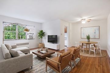 Alexandria apartment for rent - A living room with a grey couch, a wooden coffee table, and a television.