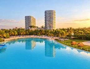 North Miami apartment for rent - A large swimming pool in the foreground with two buildings in the background.