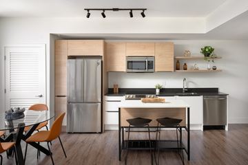 Miami apartment for rent - A modern kitchen with a dining table and chairs.