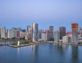 Jersey City apartment for rent - A city skyline with a body of water in the foreground.