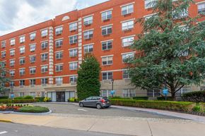 Jersey City apartment for rent - A red brick building with a tree in front of it.