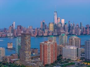 Jersey City apartment for rent - A city skyline with a large body of water in the foreground.