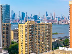 Jersey City apartment for rent - A cityscape with a large yellow building in the foreground.
