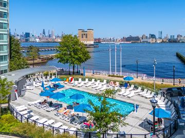 Jersey City apartment for rent - A pool area with a view of the city skyline.