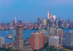 Jersey City apartment for rent - A city skyline with a large body of water in the foreground.