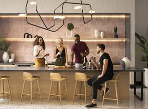 Miami apartment for rent - Four people are standing in a kitchen with a pink wallpaper.