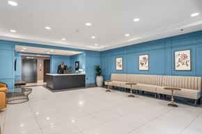 Jersey City apartment for rent - A reception area with a blue wall and a bench.