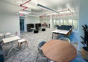 Jersey City apartment for rent - A modern office space with a wooden table in the foreground.