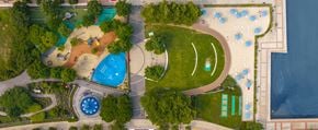 Jersey City apartment for rent - A park with a playground, a fountain, and a body of water.