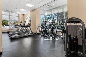 Jersey City apartment for rent - A gym with treadmills, elliptical machines, and a weight machine.