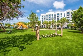 North Miami apartment for rent - A playground with a slide and a wooden structure in the foreground.