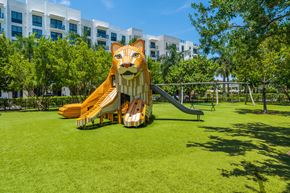 North Miami apartment for rent - A playground with a slide shaped like a lion's head.