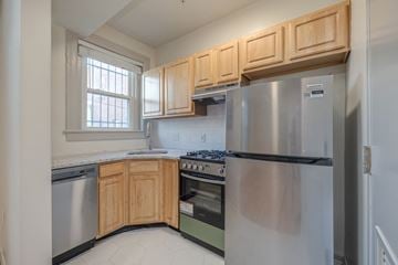 Washington apartment for rent - A kitchen with wooden cabinets and stainless steel appliances.