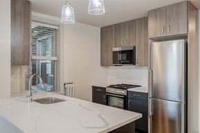 Washington apartment for rent - a kitchen with stainless steel appliances and a white counter top