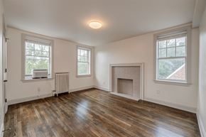 Washington apartment for rent - an empty living room with a fireplace and a tv