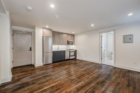 Washington apartment for rent - a living room with a kitchen and a door to a bathroom