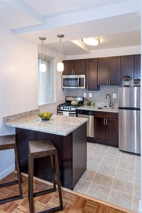 Washington apartment for rent - a kitchen with a marble counter top and stainless steel appliances