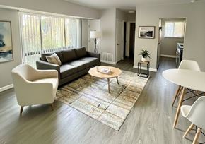 Washington apartment for rent - A living room with a couch, chairs, and a table.