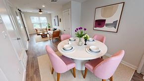 Victoria apartment for rent - A dining room with a white table and pink chairs.
