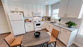 Victoria apartment for rent - A kitchen with white cabinets and a white refrigerator.
