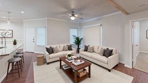Victoria apartment for rent - A living room with a white couch, a wooden coffee table, and a bar area.