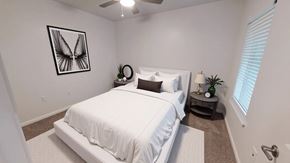 Victoria apartment for rent - A bedroom with a white bed and a picture of a butterfly on the wall.