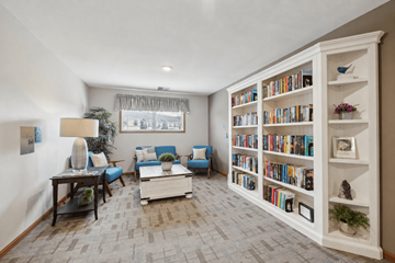 West Chanhassen apartment for rent - A living room with a bookshelf filled with books.