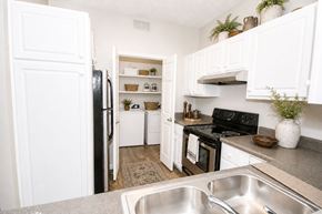 Snellville apartment for rent - A kitchen with white cabinets and a black stove top oven.