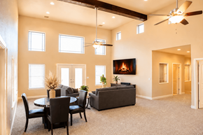 Granbury apartment for rent - A living room with a fireplace and a dining table.
