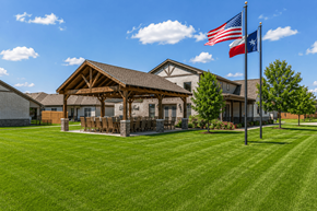 Granbury apartment for rent - A house with a flag on the lawn.