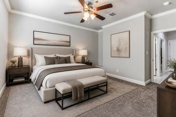 Granbury apartment for rent - A bedroom with a large bed and a ceiling fan.