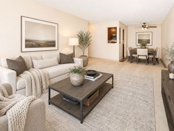 Eagan apartment for rent - A living room with a white couch, a coffee table, and a painting on the wall.