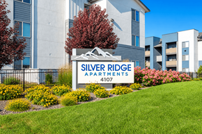 Meridian apartment for rent - Monument sign with mountain graphic and yellow flowers at Silver Ridge Apartments, Meridian