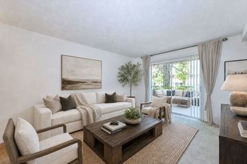 East Point townhouse for rent - A living room with a white couch, a coffee table, and a painting on the wall.