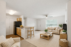 Charlottesville apartment for rent - A well-lit, spacious living room with a kitchen area in the background.