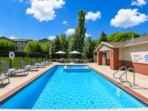 Logan apartment for rent - A swimming pool surrounded by lounge chairs and umbrellas.