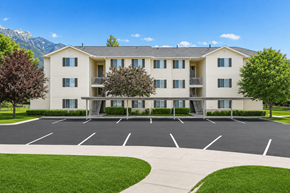Ogden apartment for rent - A large apartment complex with a parking lot in front.