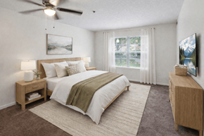 Hilliard apartment for rent - A bedroom with a large bed and a ceiling fan.