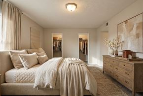 Jonesboro townhouse for rent - A bedroom with a large bed and a dresser.