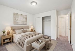 Chaska apartment for rent - A bedroom with a large bed and a painting on the wall.
