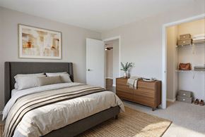 University Park apartment for rent - A bedroom with a large bed and a wooden cabinet at Arbors at Hickory Creek Apartments , Apartments, University Park, IL