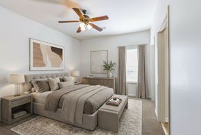 Cordova apartment for rent - A bedroom with a large bed and a ceiling fan.
