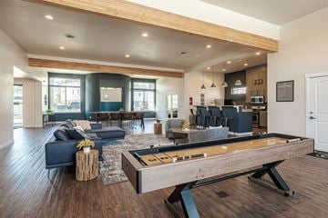 Bluffdale townhouse for rent - A billiard table is in the middle of a modern living room.