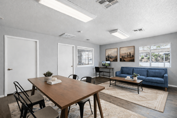 Henderson apartment for rent - A living room with a blue couch and a wooden table.