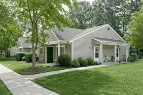 Chesterfield apartment for rent - A house with a green lawn and a tree in front.
